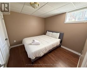 A bedroom with a bed, pillows, and a towel on the bed.