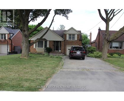 A house with a car parked in front of it.