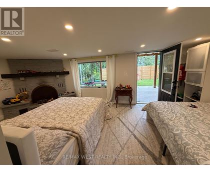 A bedroom with two beds and a fireplace.