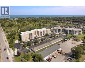 A bird's eye view of a realtor's property with a parking lot and buildings.