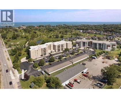 A bird's eye view of a realtor's property with a parking lot and buildings.