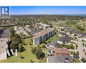 A bird's eye view of a residential area with apartment buildings and houses.