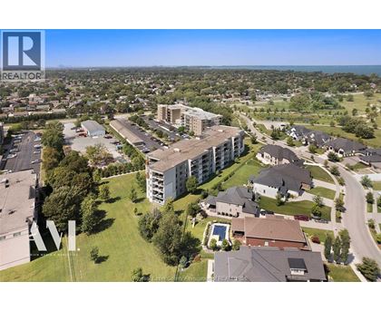 A bird's eye view of a residential area with apartment buildings and houses.