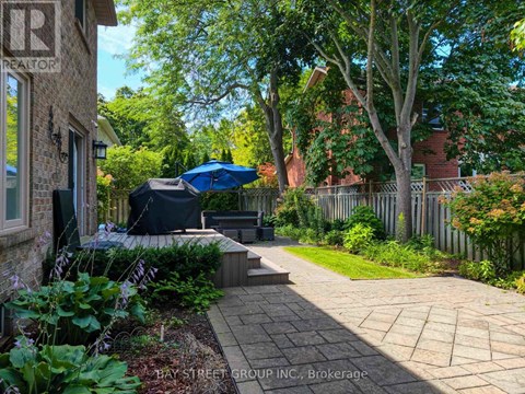 A well-maintained garden with a brick pathway leading to a patio area.