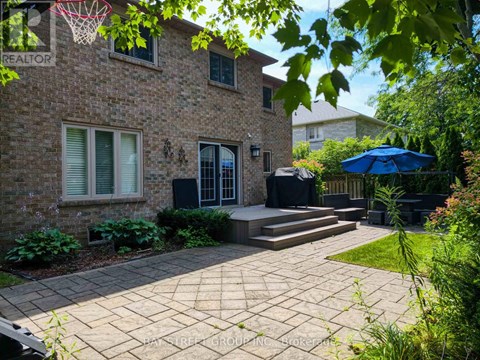 A brick house with a patio and a basketball hoop.