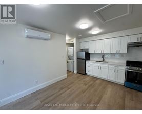 A kitchen with white cabinets and a blue oven.