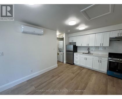 A kitchen with white cabinets and a blue oven.