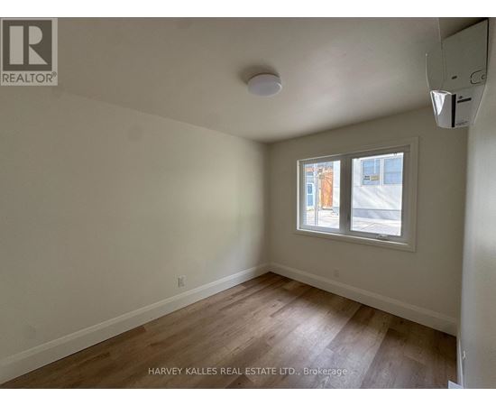 A room with a window showing an outdoor view.