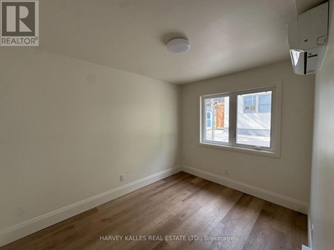 A room with a window showing an outdoor view.