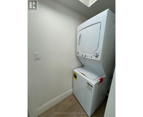 A white oven in a room with a light switch on the wall.