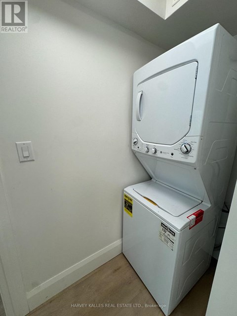 A white oven in a room with a light switch on the wall.