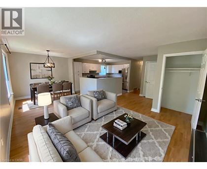 A well-lit living room with a white sofa set and a coffee table.