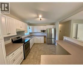 A kitchen with white cabinets and a black stove top oven.