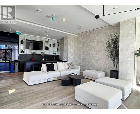 A living room with a white couch and a black coffee table.