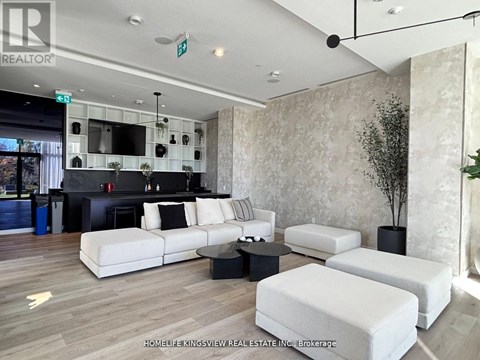 A living room with a white couch and a black coffee table.