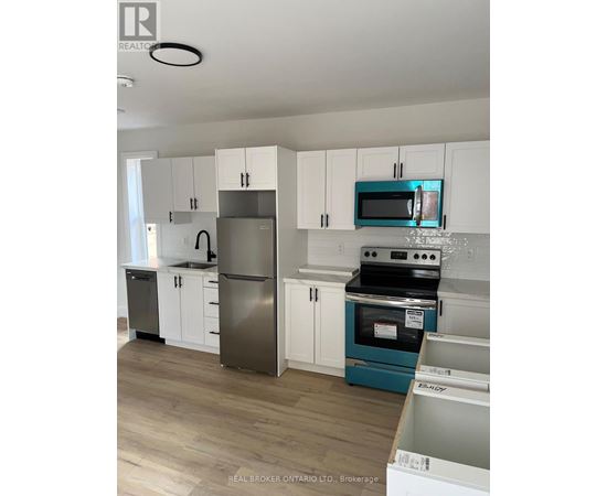 A kitchen with white cabinets and a blue oven.