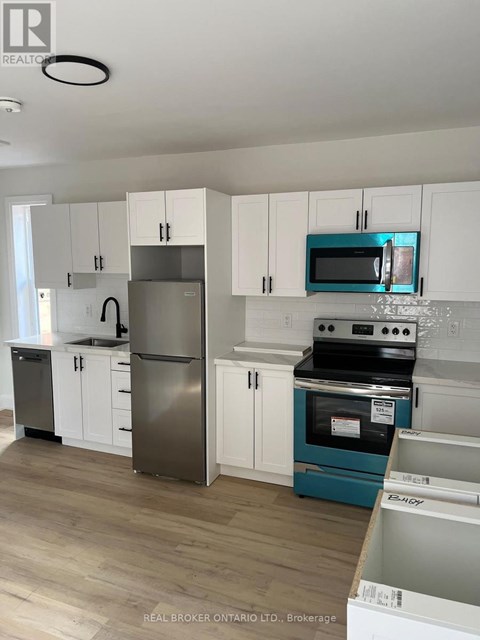 A kitchen with white cabinets and a blue oven.