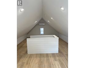 A room with a window and a bed in it.