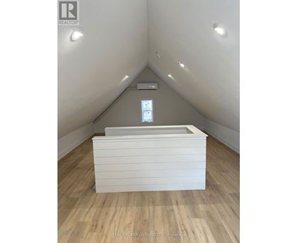 A room with a window and a bed in it.