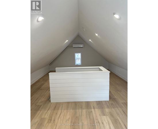 A room with a window and a bed in it.