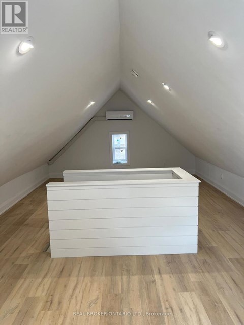 A room with a window and a bed in it.