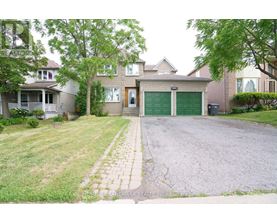 A house with a driveway and a green garage door.