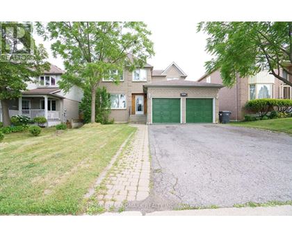 A house with a driveway and a green garage door.