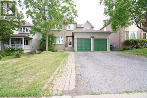 A house with a driveway and a green garage door.