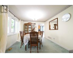 A dining room with a table set for six.