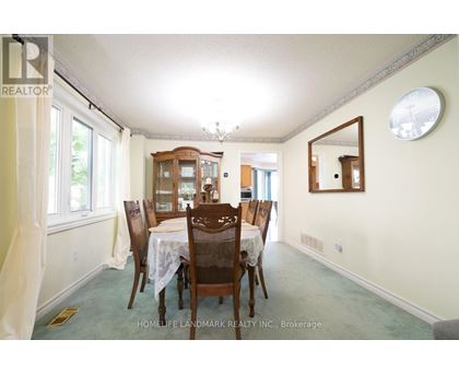 A dining room with a table set for six.