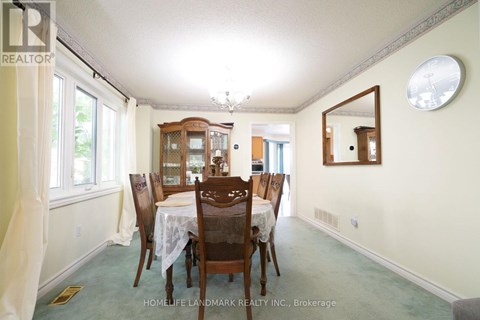 A dining room with a table set for six.
