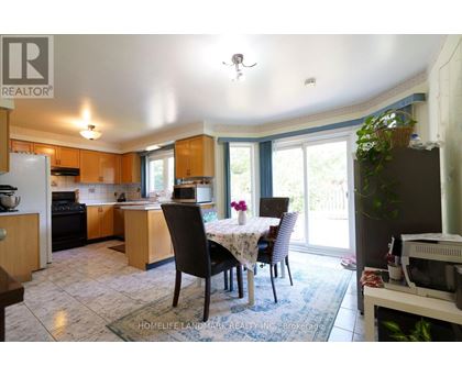 A kitchen with a table and chairs in front of a window.