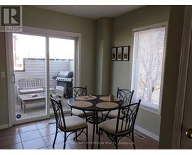A dining room with a table set for four.