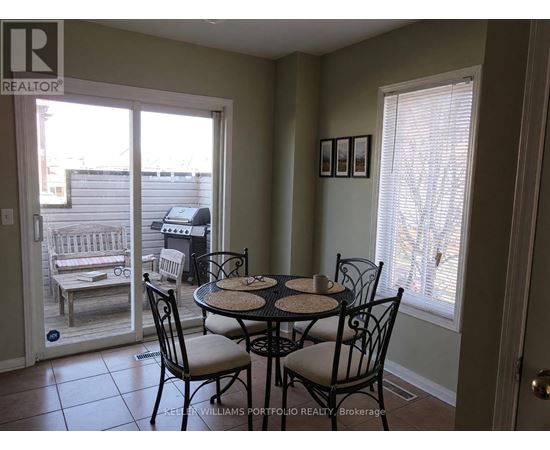 A dining room with a table set for four.