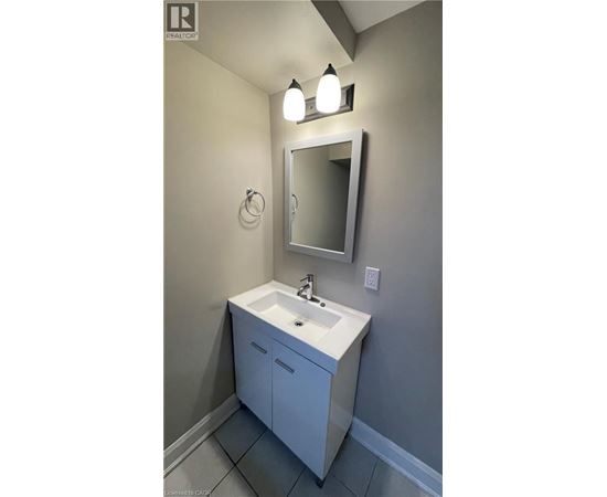A bathroom with a sink and a mirror.