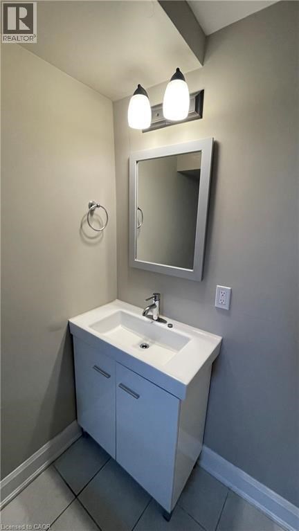 A bathroom with a sink and a mirror.