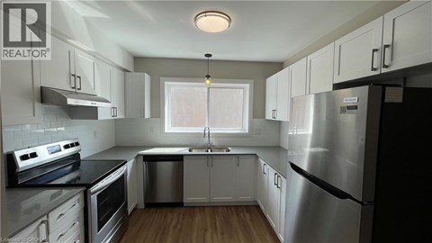 A modern kitchen with stainless steel appliances and white cabinets.