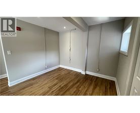 A room with wooden flooring and a sliding door.