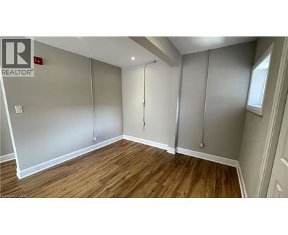 A room with wooden flooring and a sliding door.