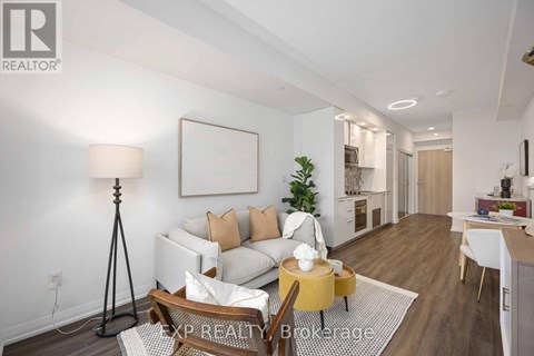 A well-lit living room with a white sofa and a wooden coffee table.