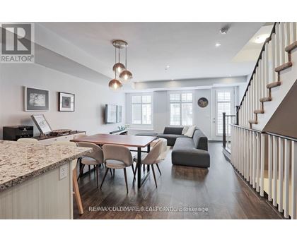A modern dining room with a table set for four.
