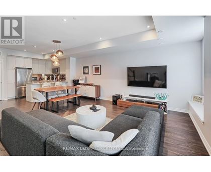 A living room with grey couches and a television.