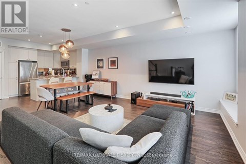 A living room with grey couches and a television.