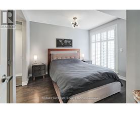 A bedroom with a large bed and a chandelier.
