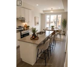 A kitchen with a large island and chairs.