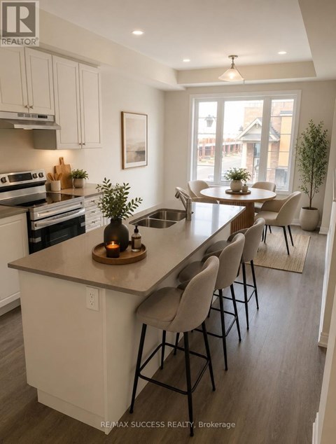 A kitchen with a large island and chairs.