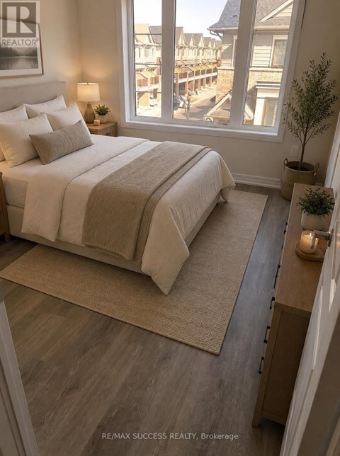 A bedroom with a large bed and a view of a deck outside the window.