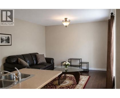 A living room with a black couch and a coffee table.