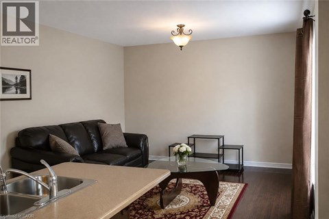 A living room with a black couch and a coffee table.