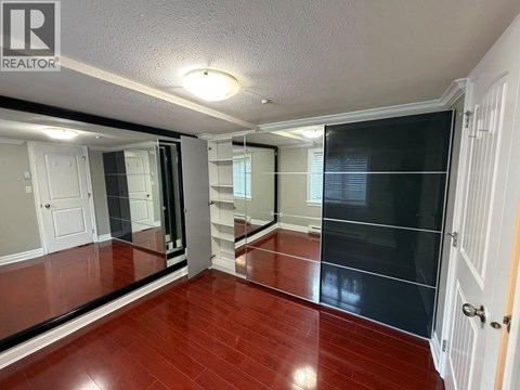 A room with a wooden floor and a sliding door.